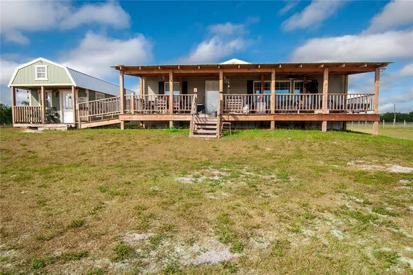 a view of a house with a yard patio and swimming pool