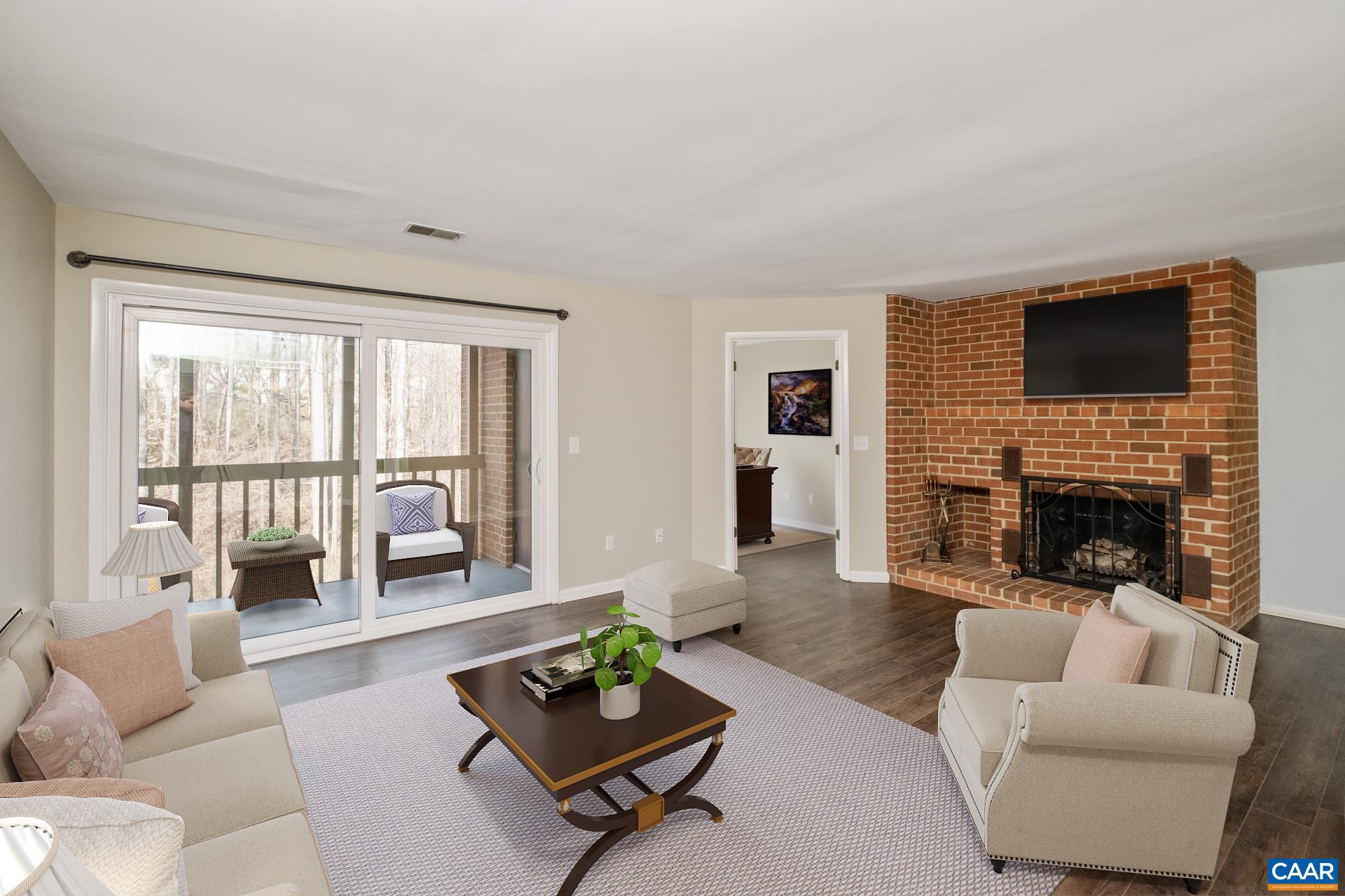111 Turtle Creek Road, Unit 2 Charlottesville, VA 22901 - Photo 1 of 22 a living room with furniture a fireplace and a flat screen tv