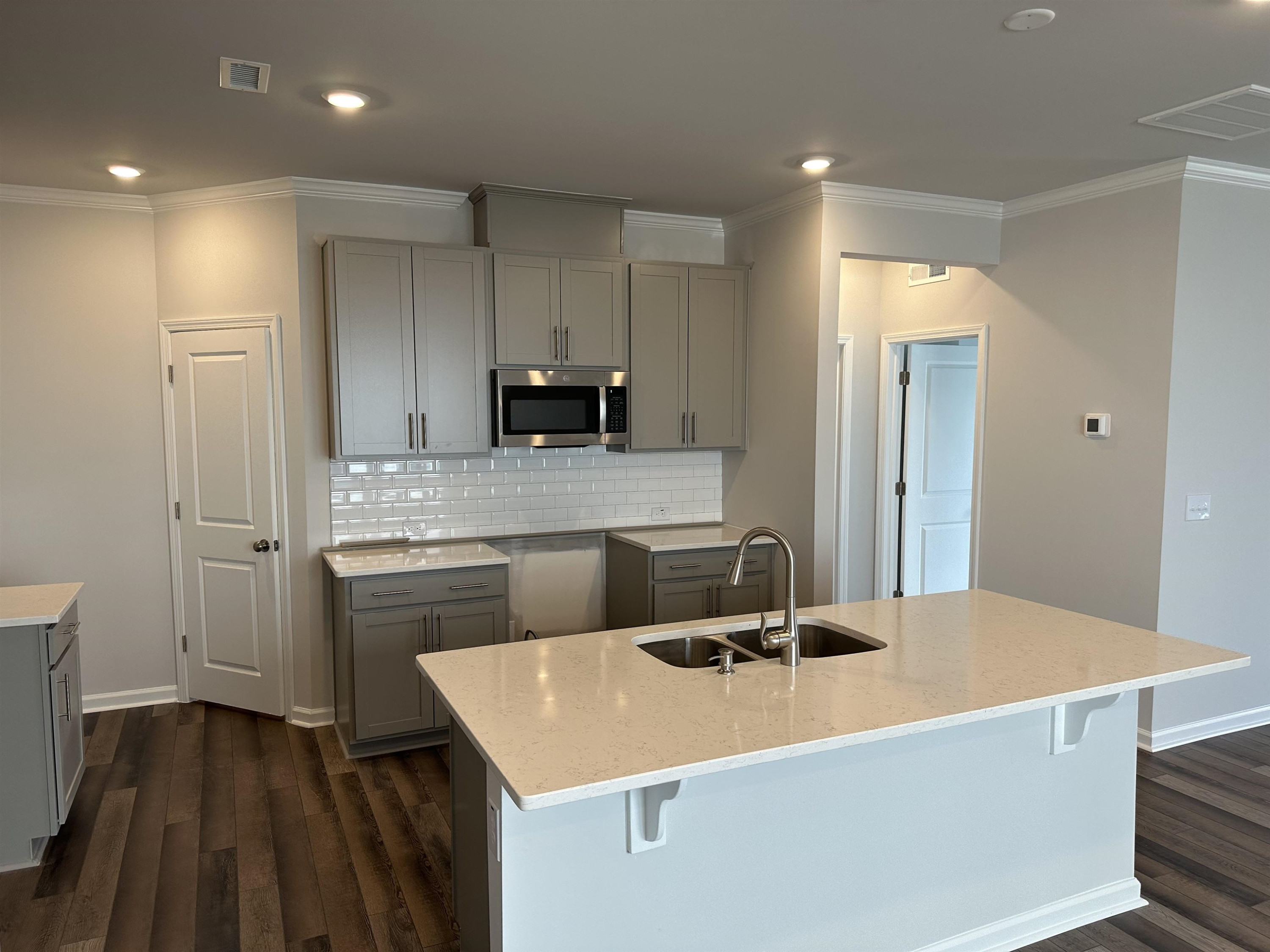 2509 Salt River Lane, Unit DAVIDSON C Raleigh, NC 27616 - Photo 5 of 6 a kitchen with kitchen island a sink stainless steel appliances and cabinets