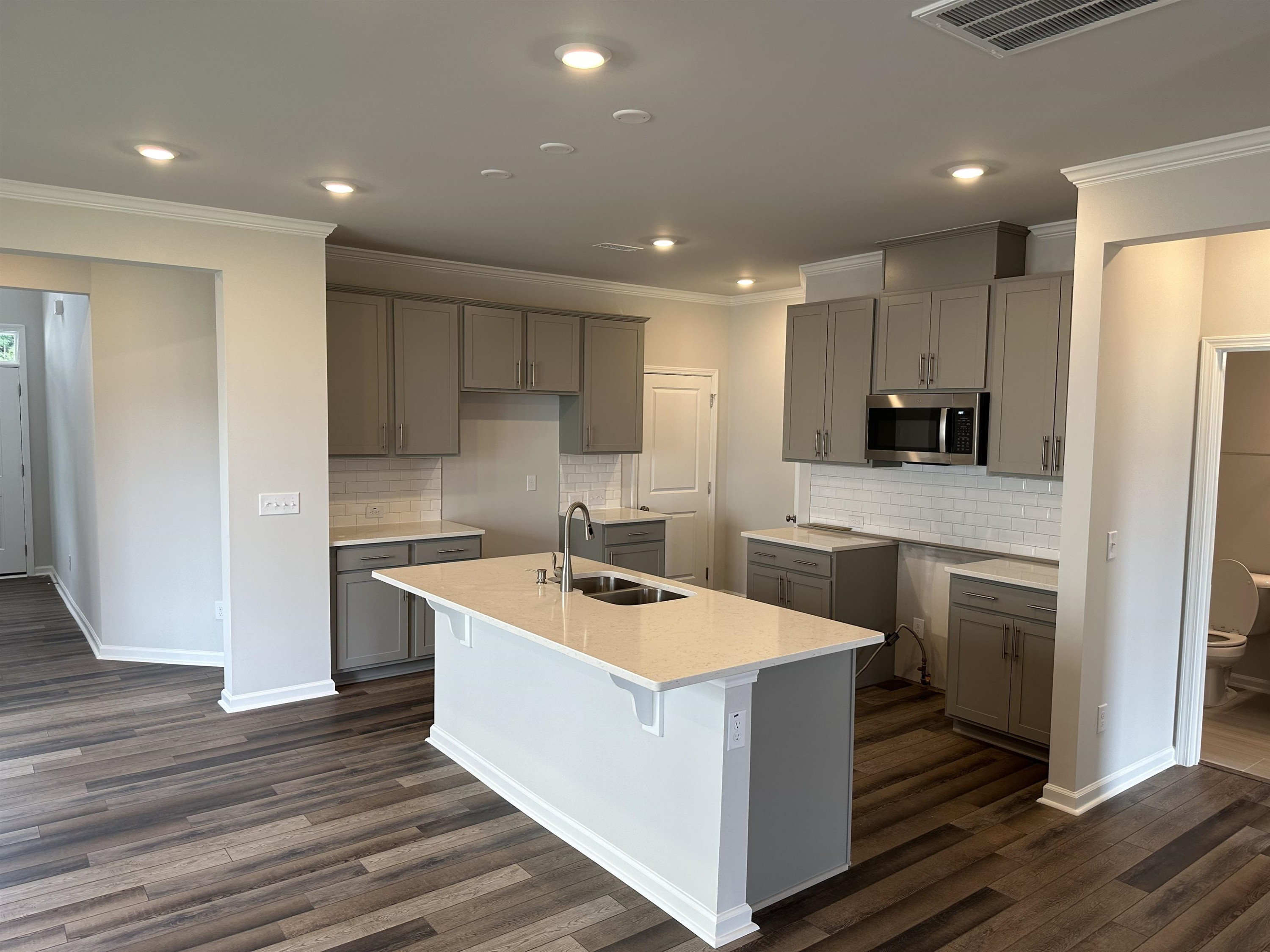2509 Salt River Lane, Unit DAVIDSON C Raleigh, NC 27616 - Photo 6 of 6 a kitchen with kitchen island a sink stove and refrigerator