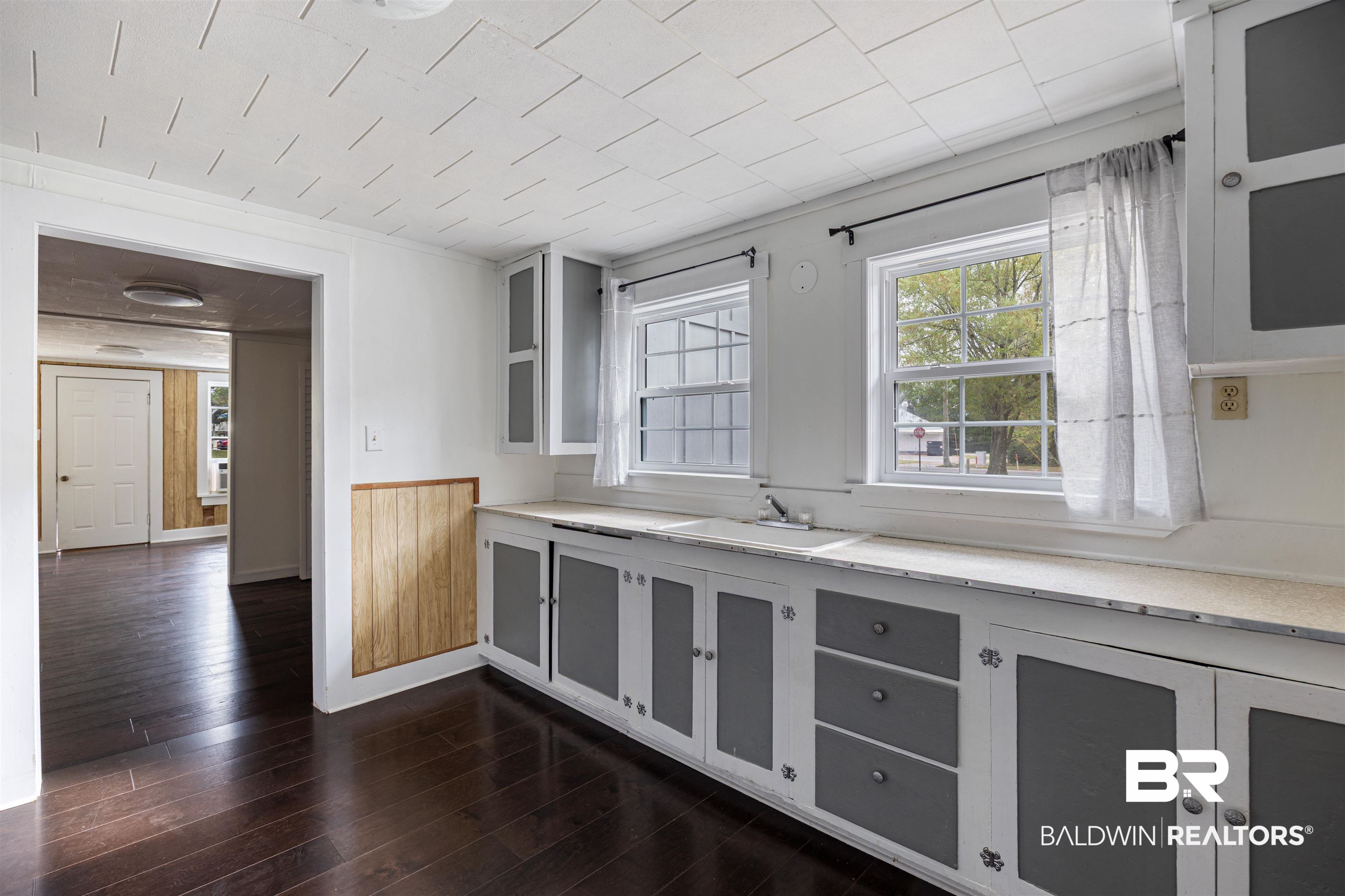 112 South Juniper Street Foley, AL 36535 - Photo 20 of 64 Kitchen featuring dark wood-style flooring and a sink