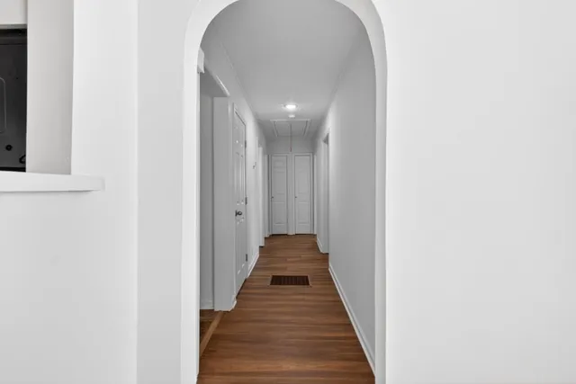 a view of a hallway with wooden floor
