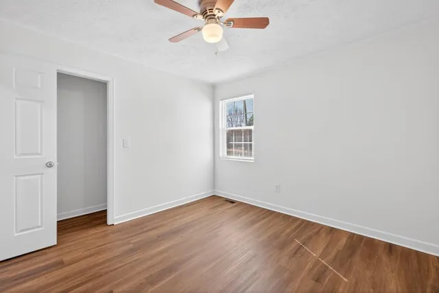 wooden floor in an empty room with a window
