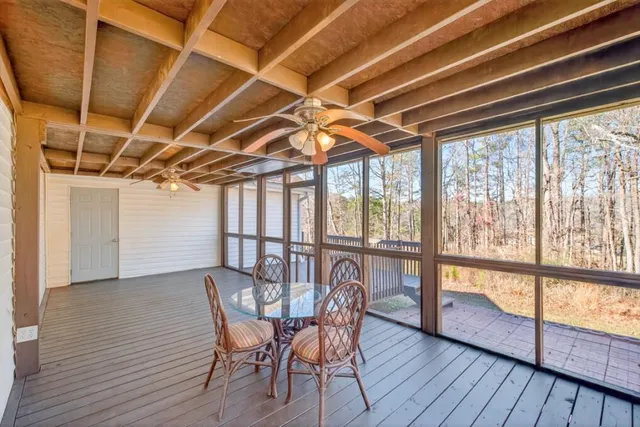 a view of a dining room with furniture wooden floor and a window