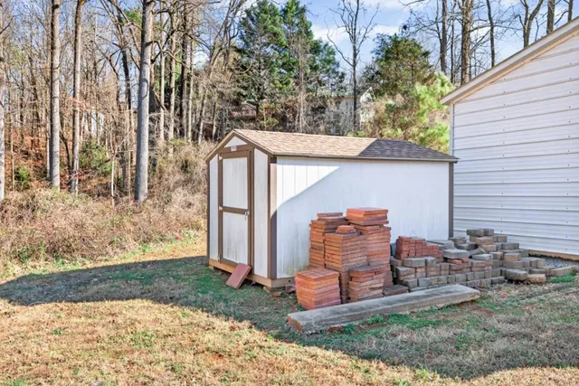 a view of a chairs and table in backyard