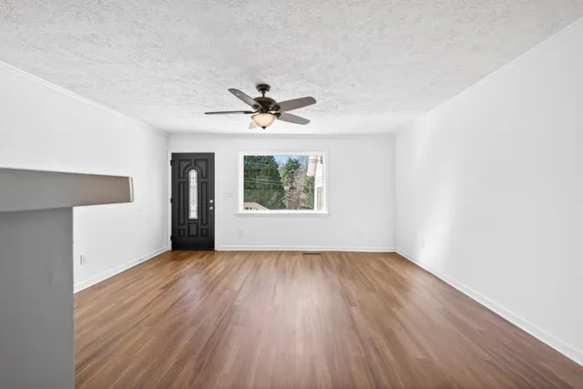 wooden floor in an empty room with a window