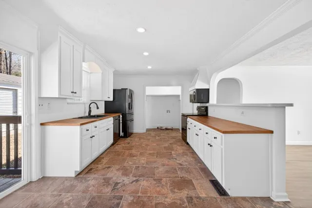 a kitchen with granite countertop a sink and cabinets