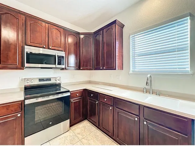 a view of an empty room with a ceiling fan