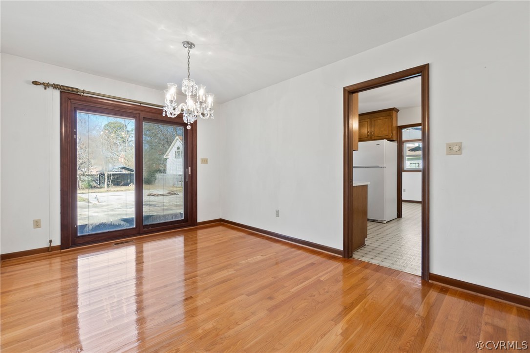 102 Meadowfield Road Yorktown, VA 23692 - Photo 7 of 21 Chandelier and hardwoods.