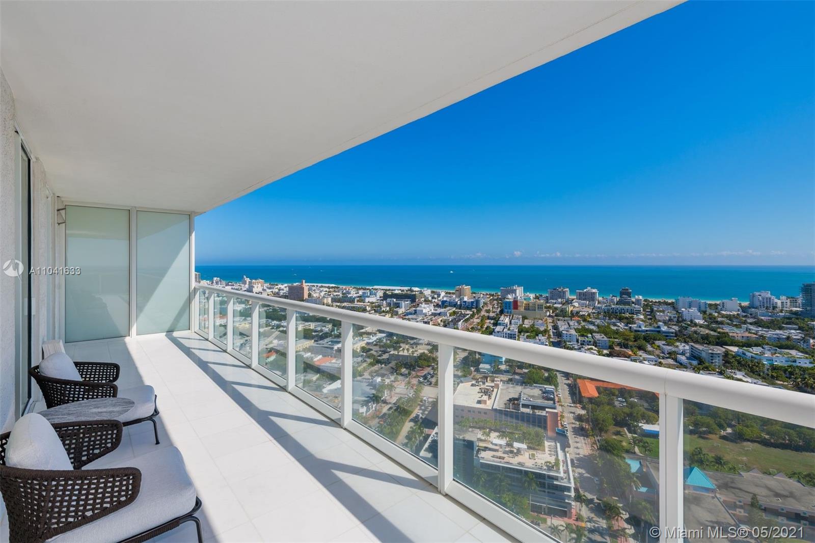 a view of a balcony with two chairs and a table