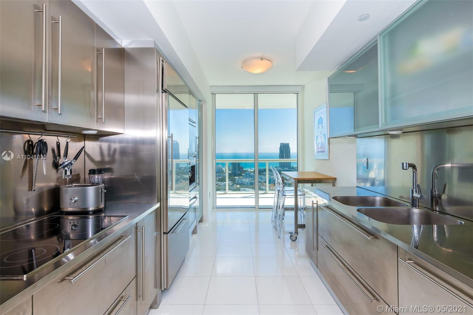 450 Alton Road, Unit 3207 Miami Beach, FL 33139 - Photo 11 of 31 a kitchen with stainless steel appliances granite countertop a sink and cabinets
