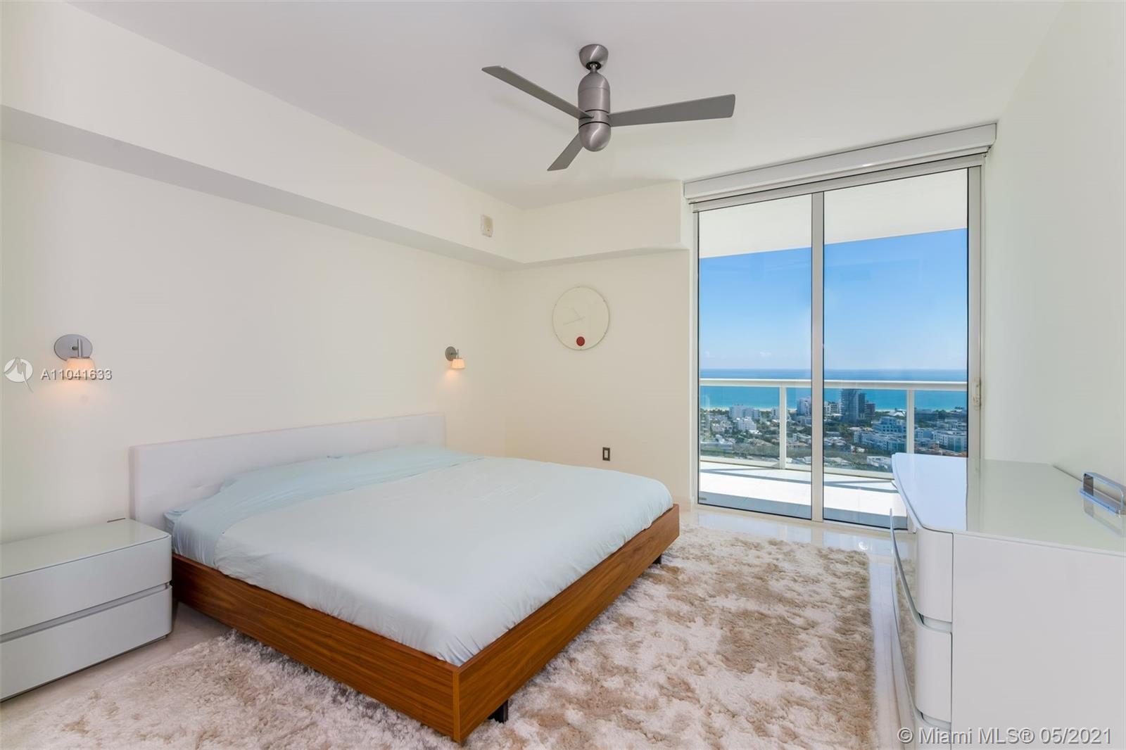 450 Alton Road, Unit 3207 Miami Beach, FL 33139 - Photo 13 of 31 a bed sitting in a room next to a window