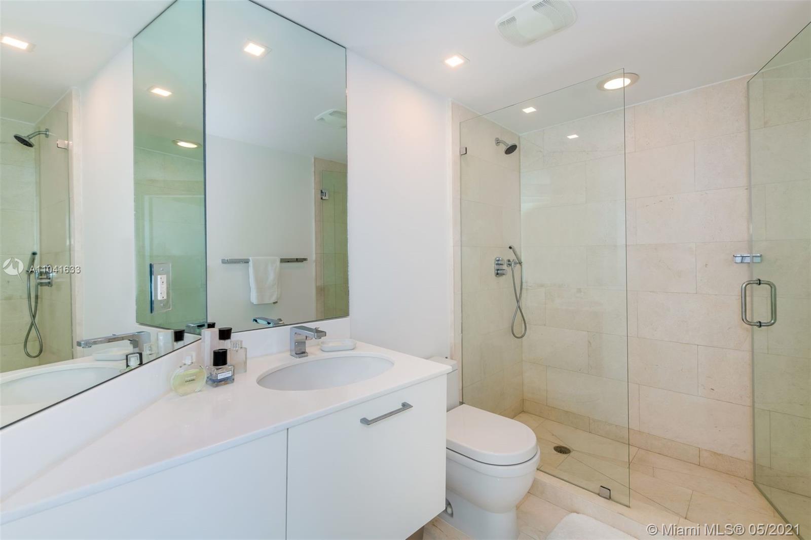 450 Alton Road, Unit 3207 Miami Beach, FL 33139 - Photo 14 of 31 a bathroom with a sink toilet and shower