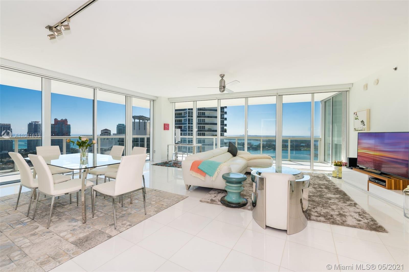 450 Alton Road, Unit 3207 Miami Beach, FL 33139 - Photo 15 of 31 a living room with furniture a rug and a large window