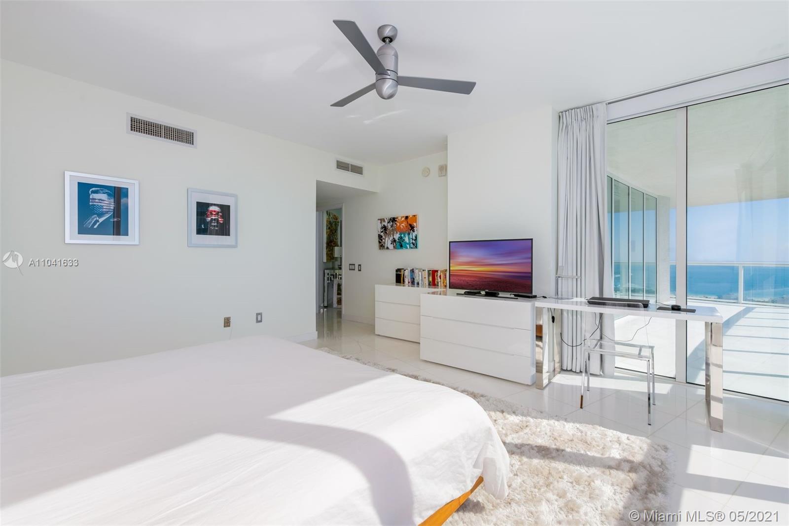 450 Alton Road, Unit 3207 Miami Beach, FL 33139 - Photo 5 of 31 a bedroom with a bed and a chair