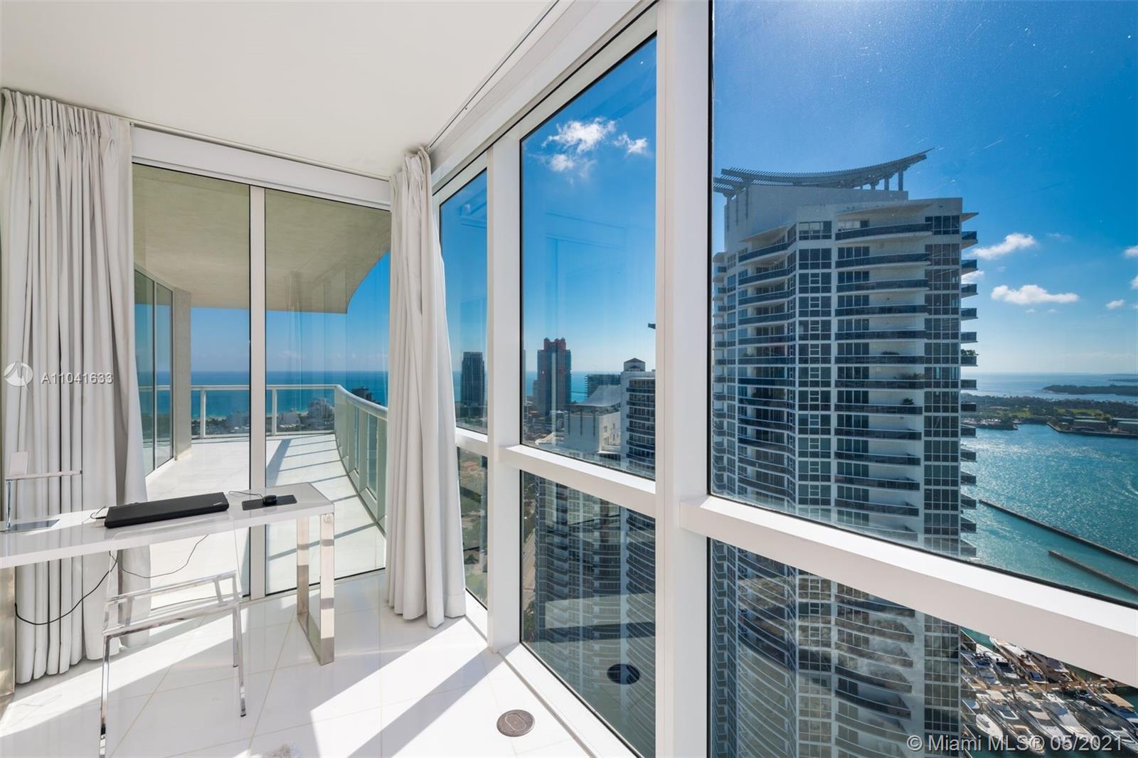 450 Alton Road, Unit 3207 Miami Beach, FL 33139 - Photo 6 of 31 a view of balcony with a floor to ceiling window and chair