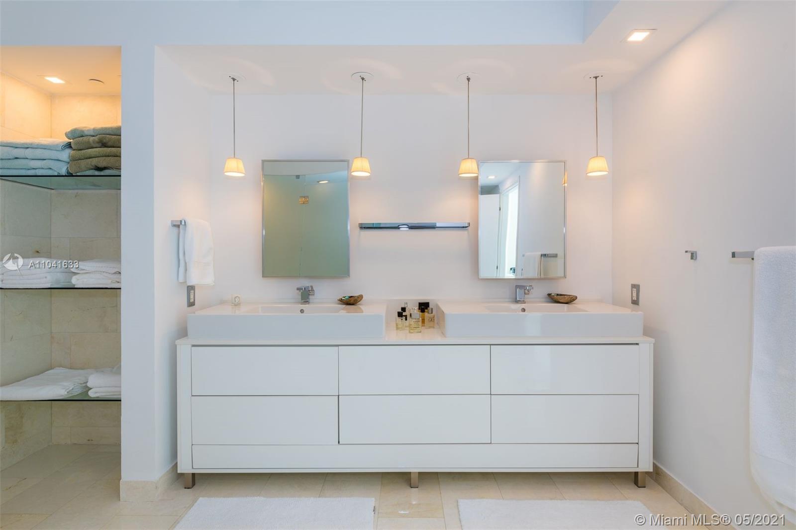 450 Alton Road, Unit 3207 Miami Beach, FL 33139 - Photo 10 of 31 a bathroom with a double vanity sink and mirror