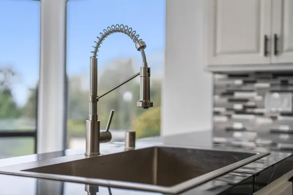 a view of empty room with wooden floor and fireplace