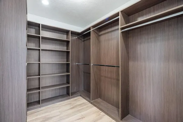 an empty room with wooden floor and door