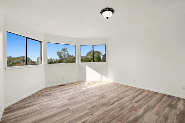 a bedroom with a large bed and a window