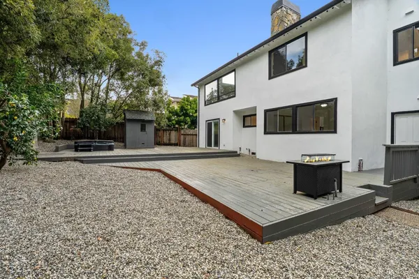an aerial view of a house with swimming pool and lake view