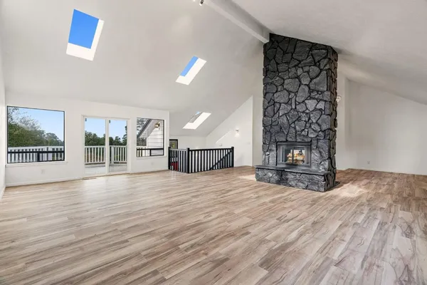 a living room with fireplace furniture and a large window