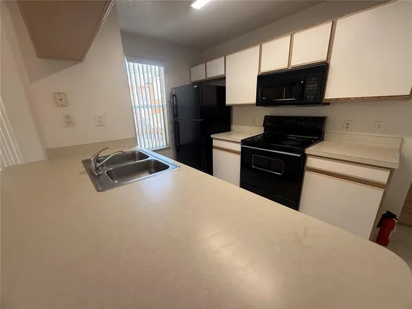 a kitchen with a refrigerator stove and microwave