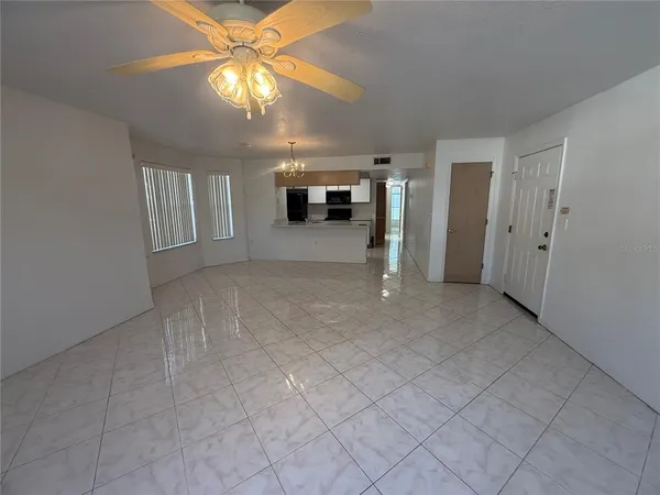 a view of a livingroom with furniture and chandelier fan