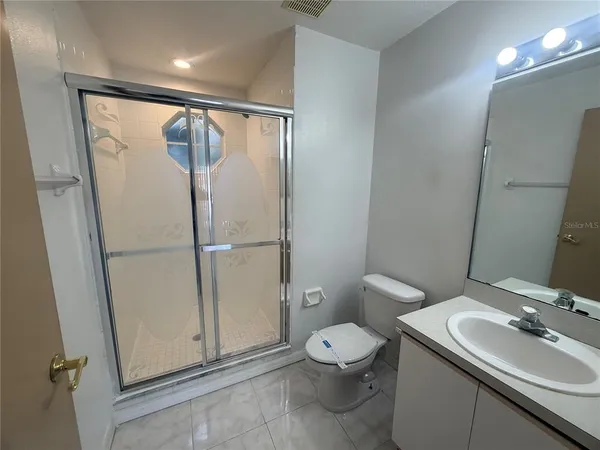 a bathroom with a toilet sink and a mirror