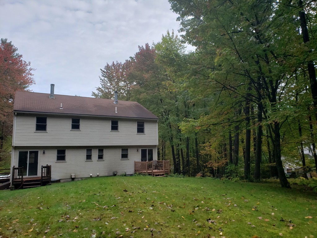 68 Lawton Road, Unit B Shirley, MA 01464 - Photo 13 of 14 a view of a house with a big yard and large trees