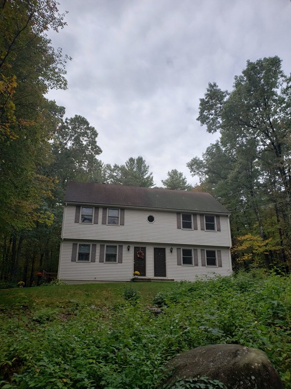 68 Lawton Road, Unit B Shirley, MA 01464 - Photo 2 of 14 a view of a house with yard and trees in the background
