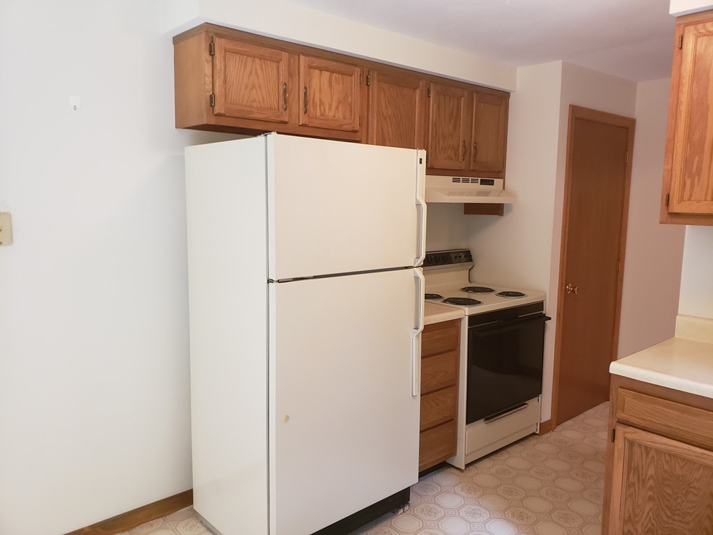 68 Lawton Road, Unit B Shirley, MA 01464 - Photo 3 of 14 a kitchen with a refrigerator and a stove