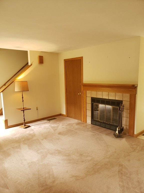 68 Lawton Road, Unit B Shirley, MA 01464 - Photo 8 of 14 a view of an empty room with a fireplace