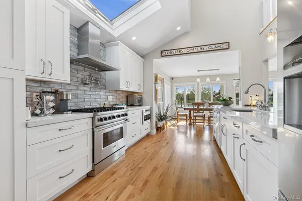 a kitchen with stainless steel appliances a stove a sink and a refrigerator