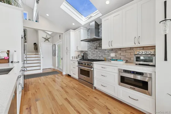 a bathroom with a sink a mirror and a bath tub