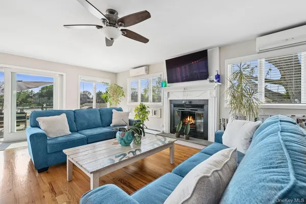 a living room with furniture a flat screen tv and a fireplace