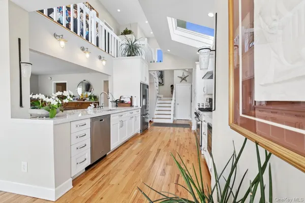 a kitchen with a dining table chairs cabinets and stainless steel appliances