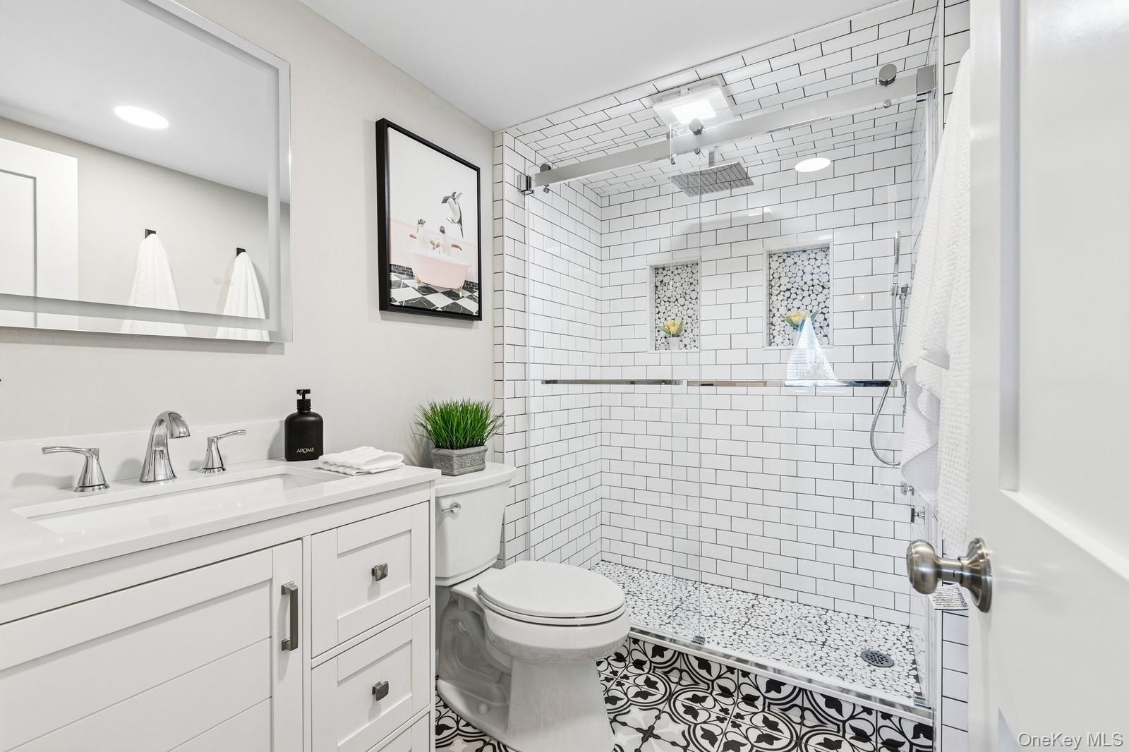 81 Beach Road Aquebogue, NY 11901 - Photo 27 of 34 a bathroom with a sink a toilet and shower