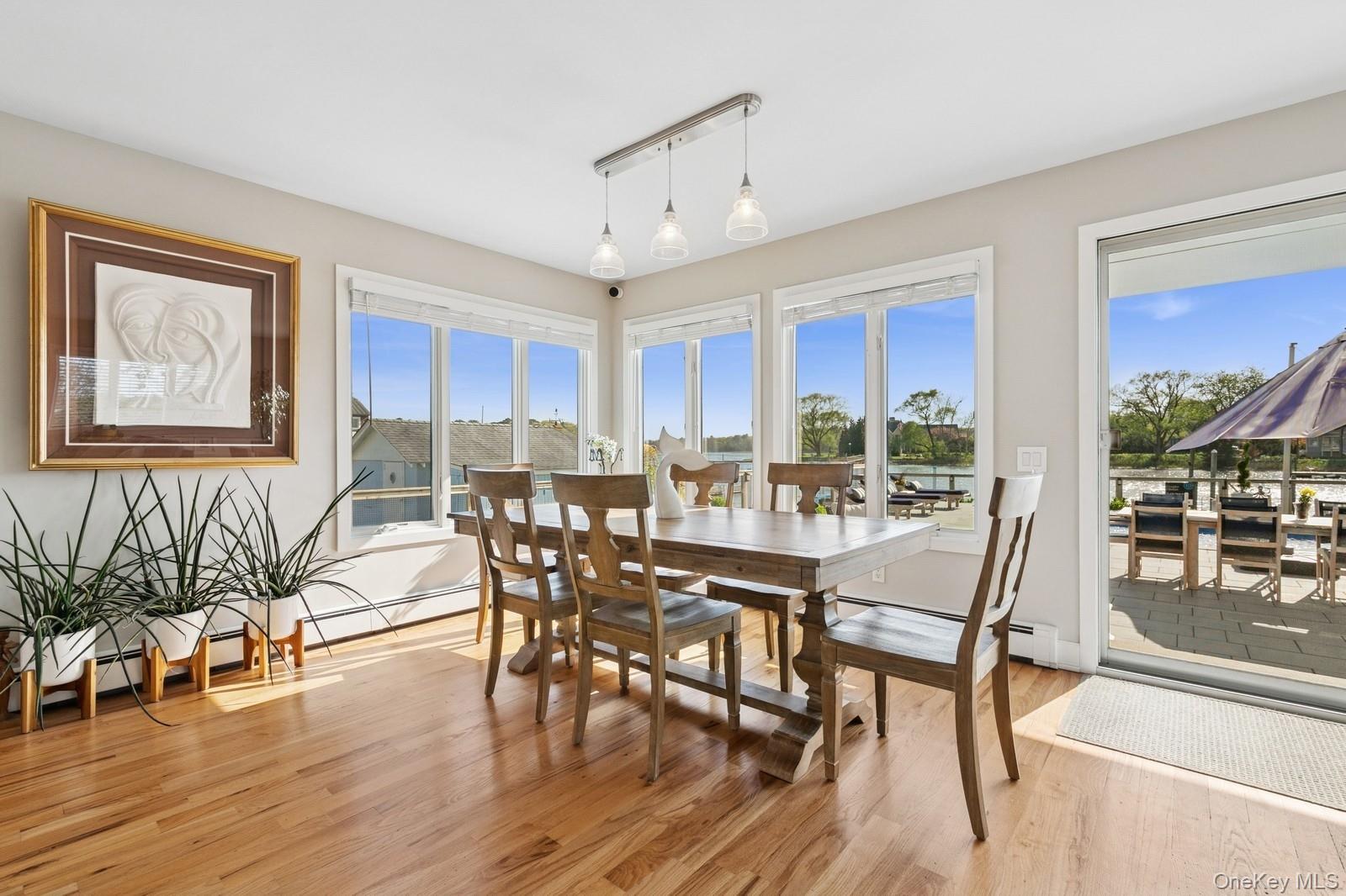 81 Beach Road Aquebogue, NY 11901 - Photo 3 of 34 a view of a dining room with furniture window and wooden floor