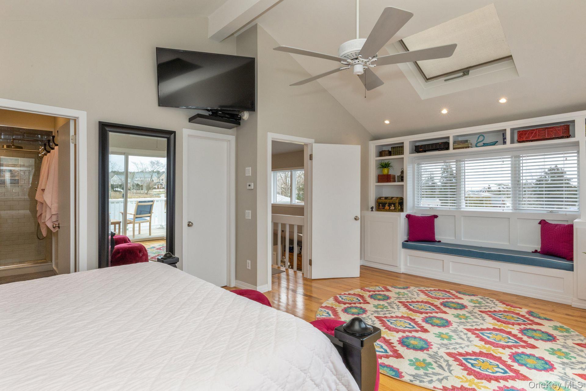 81 Beach Road Aquebogue, NY 11901 - Photo 31 of 34 a bedroom with a bed and a flat screen tv