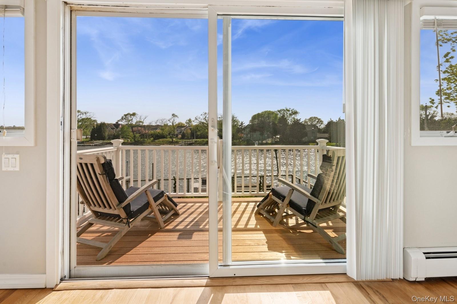 81 Beach Road Aquebogue, NY 11901 - Photo 32 of 34 a view of a balcony with lake view and a couches