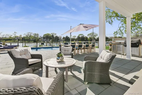a view of a patio with couches dining table and chairs with garden view