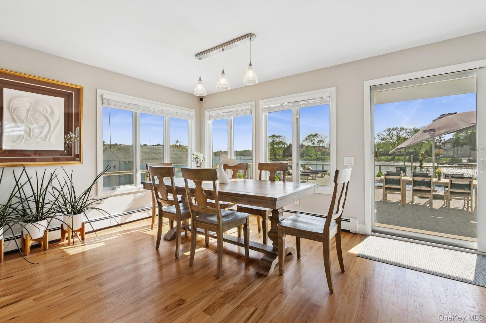 81 Beach Road Aquebogue, NY 11901 - Photo 10 of 34 a view of a dining room with furniture window and wooden floor