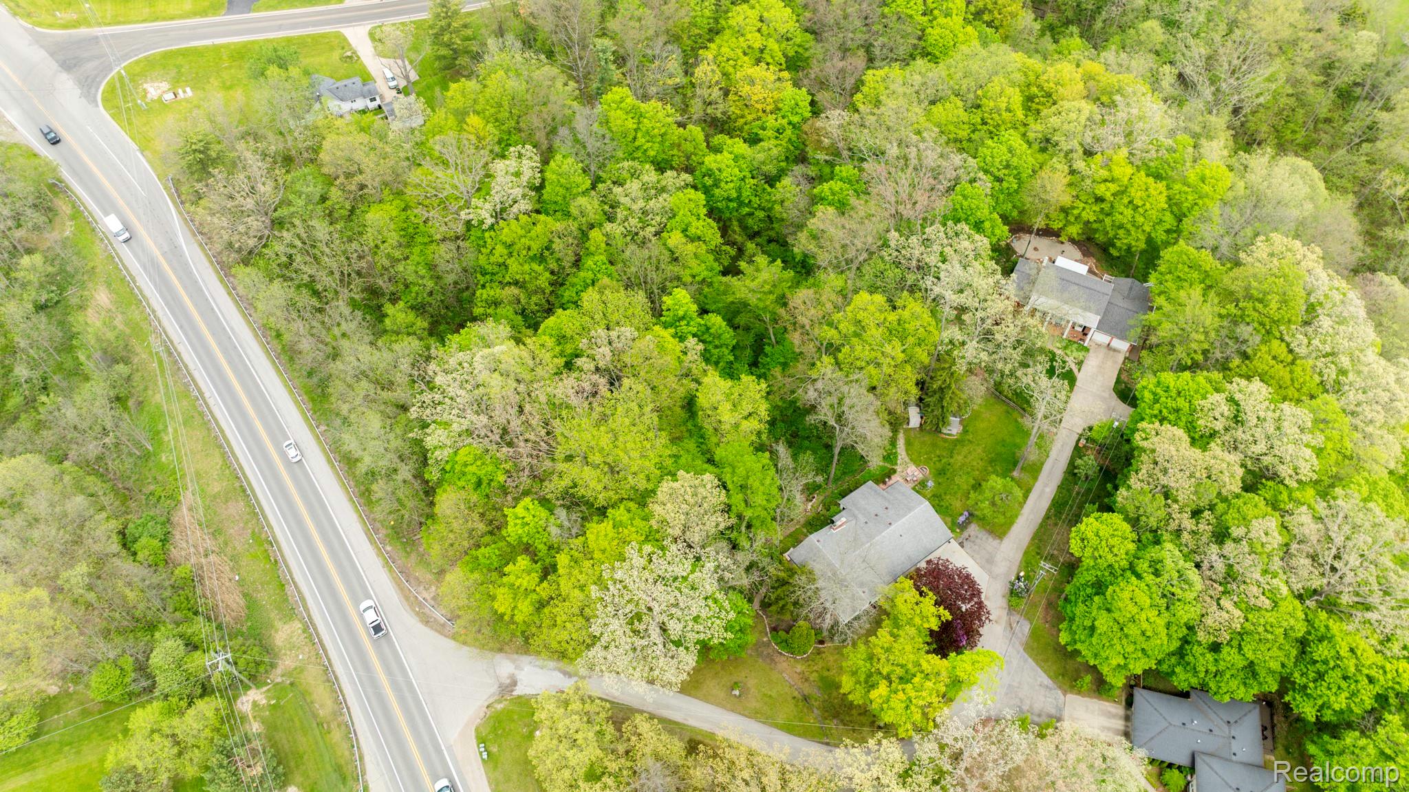 3560 North Road North Street, MI 48049 - Photo 6 of 53 Drone / aerial view of a heavily wooded area