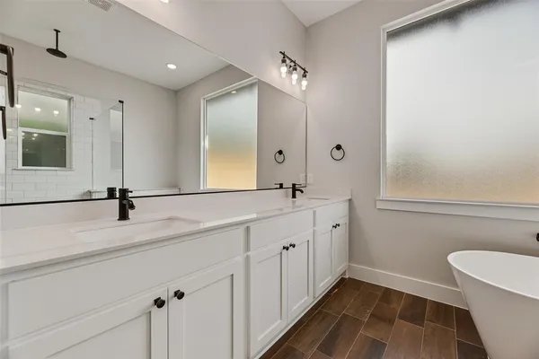 a bathroom with a double vanity sink mirror and toilet