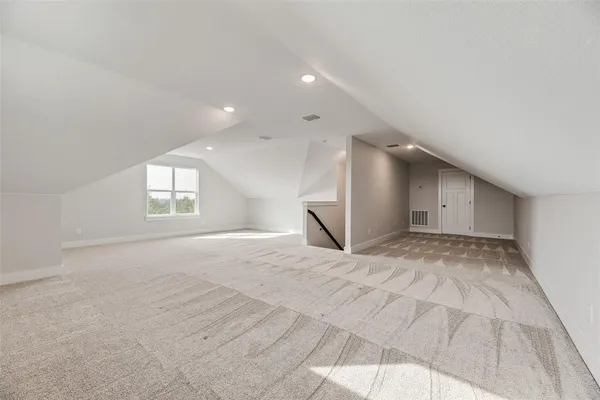 a view of an empty room and window and wooden floor