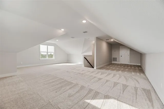 a view of an empty room and window and wooden floor