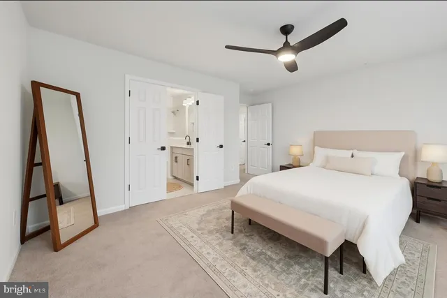 a spacious bedroom with a bed and a ceiling fan