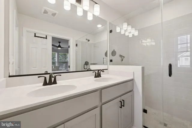 a bathroom with a sink double vanity and a mirror