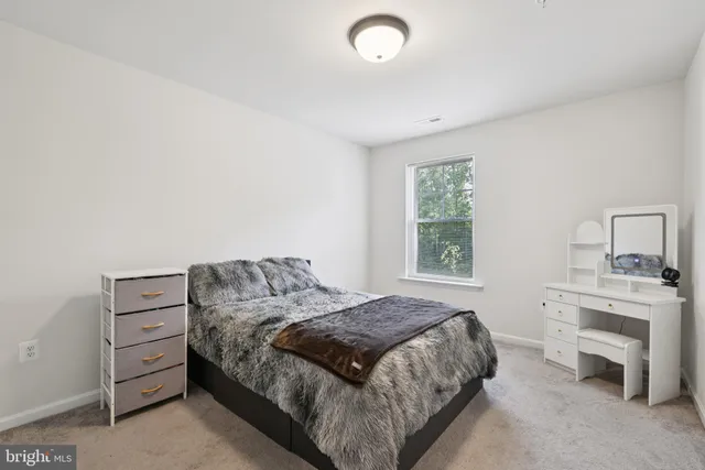 a bedroom with a bed and a fireplace